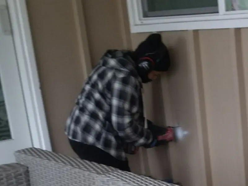 Professional electrician installing an exterior outlet in Travis Ranch